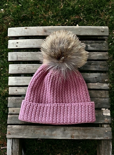 English knit hat with natural fur pompom.