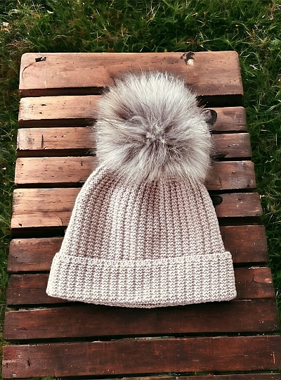 English knit hat with natural fur pompom.