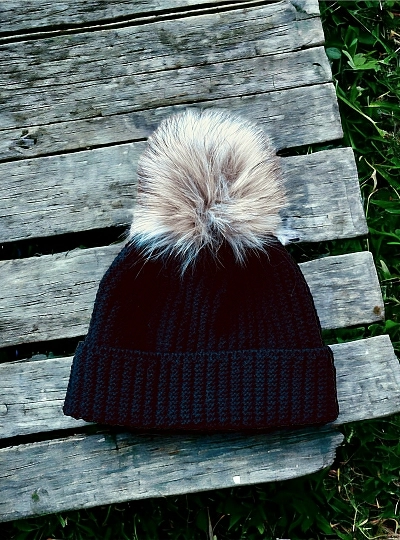 English knit hat with natural fur pompom.