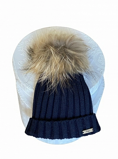 Ribbed hat in various colors. She wears a hair pompom.